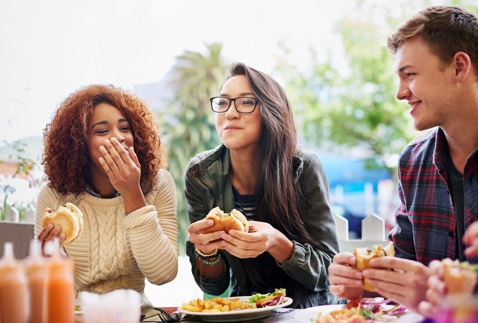 gastroesophageal reflux disease Group of friends happily eating burgers at a restaurant